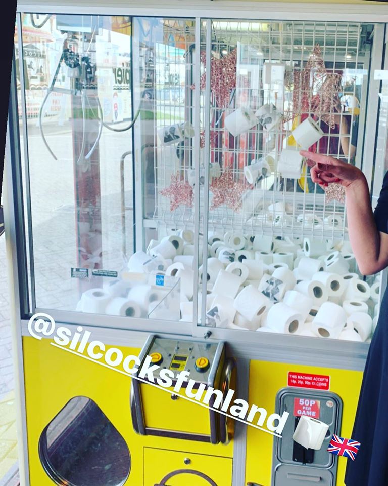People can win toilet rolls at a games machine at Silcock's Funland in Southport, as their response to the Coronavirus