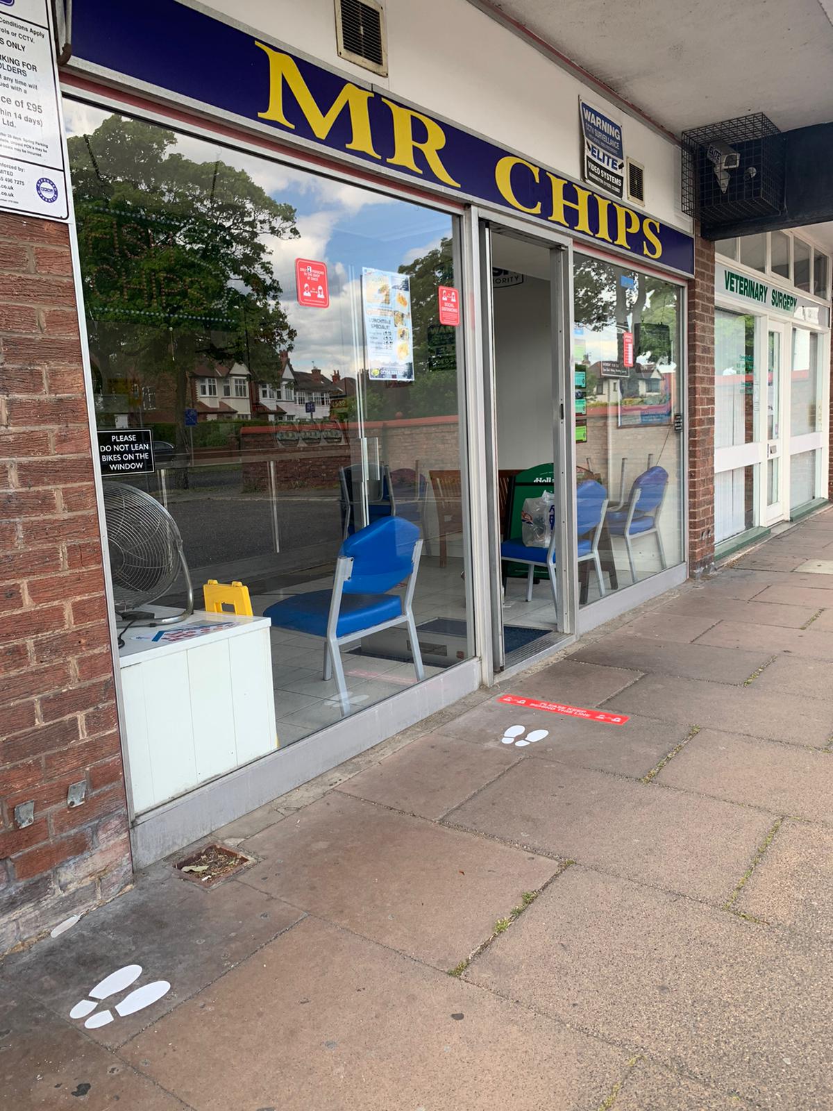 New social distancing signs created by Southport firm Magnetic Activation outside Mr Chips chippy in Churchtown in Southport