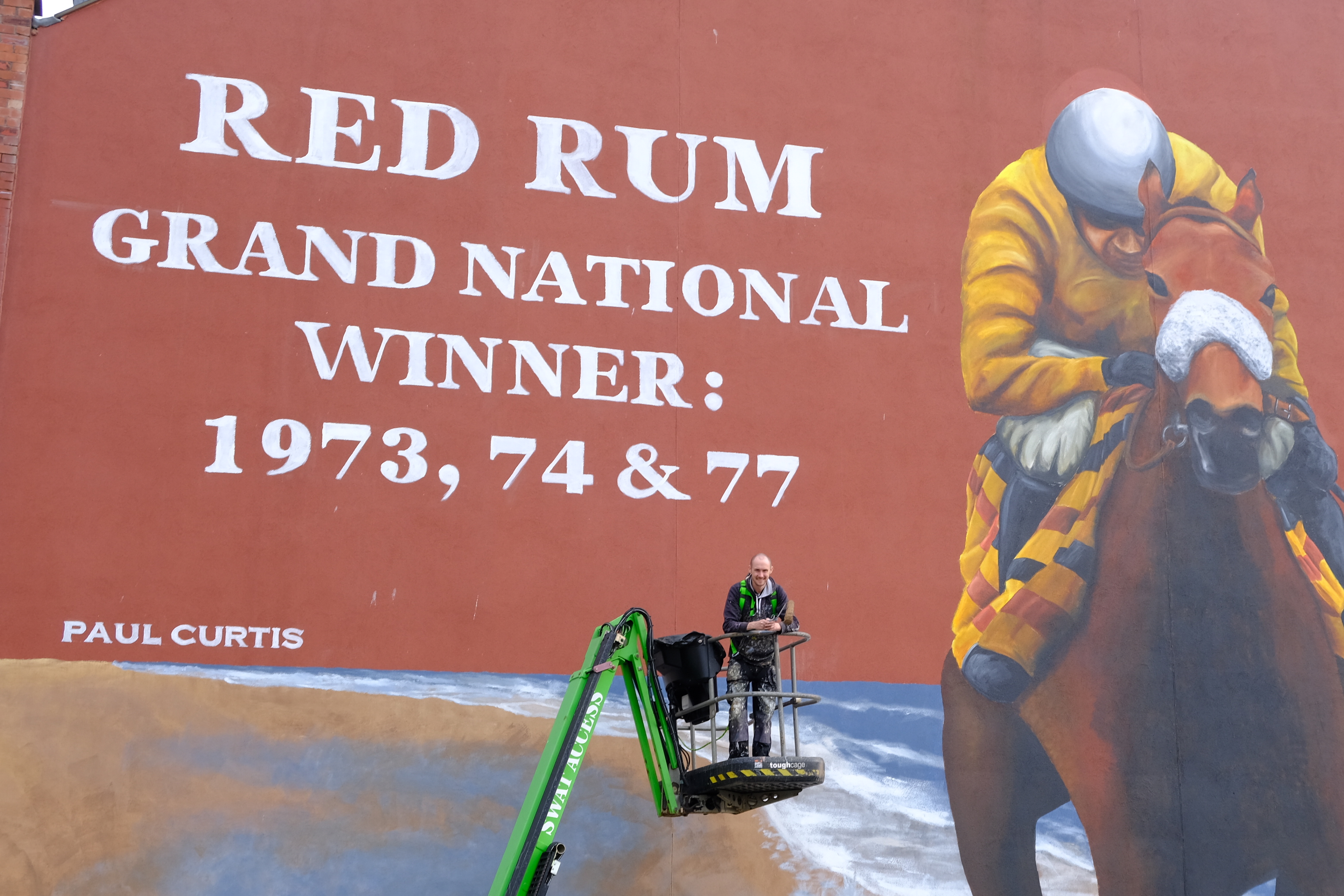 Liverpool mural artist Paul Curtis and the huge Red Rum artwork in Southport