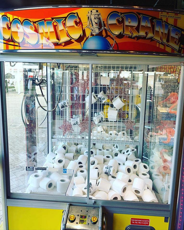 People can win toilet rolls at a games machine at Silcock's Funland in Southport, as their response to the Coronavirus