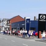 People queue for the reopening of the Sports Direct store in Southport on Monday June 15, 2020