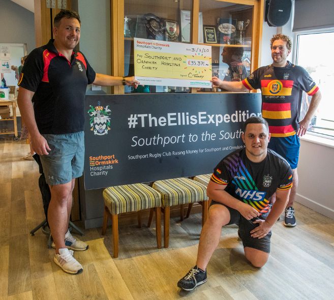 Col Toohey (left), Gareth Lang (right) and James Cook (front) with a cheque for £35,371 which was raised through The Ellis Expedition. Photo by Angus Matheson of Wainwright & Matheson Photography