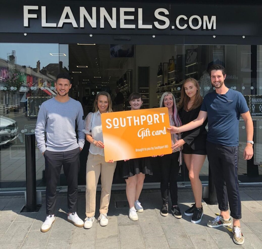 Flannels manager Grant Tindell (right) and staff members welcome the arrival of the brand new Southport Gift Card
