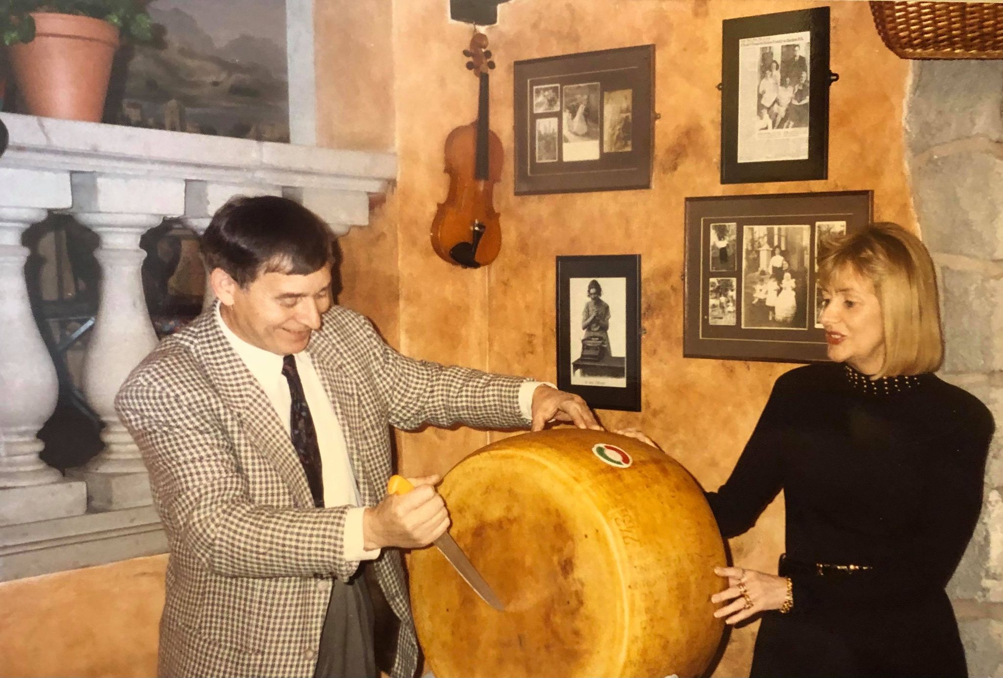 Erasmo and Eileen Grossi with one of their Reggiano parmesan cheese wheels