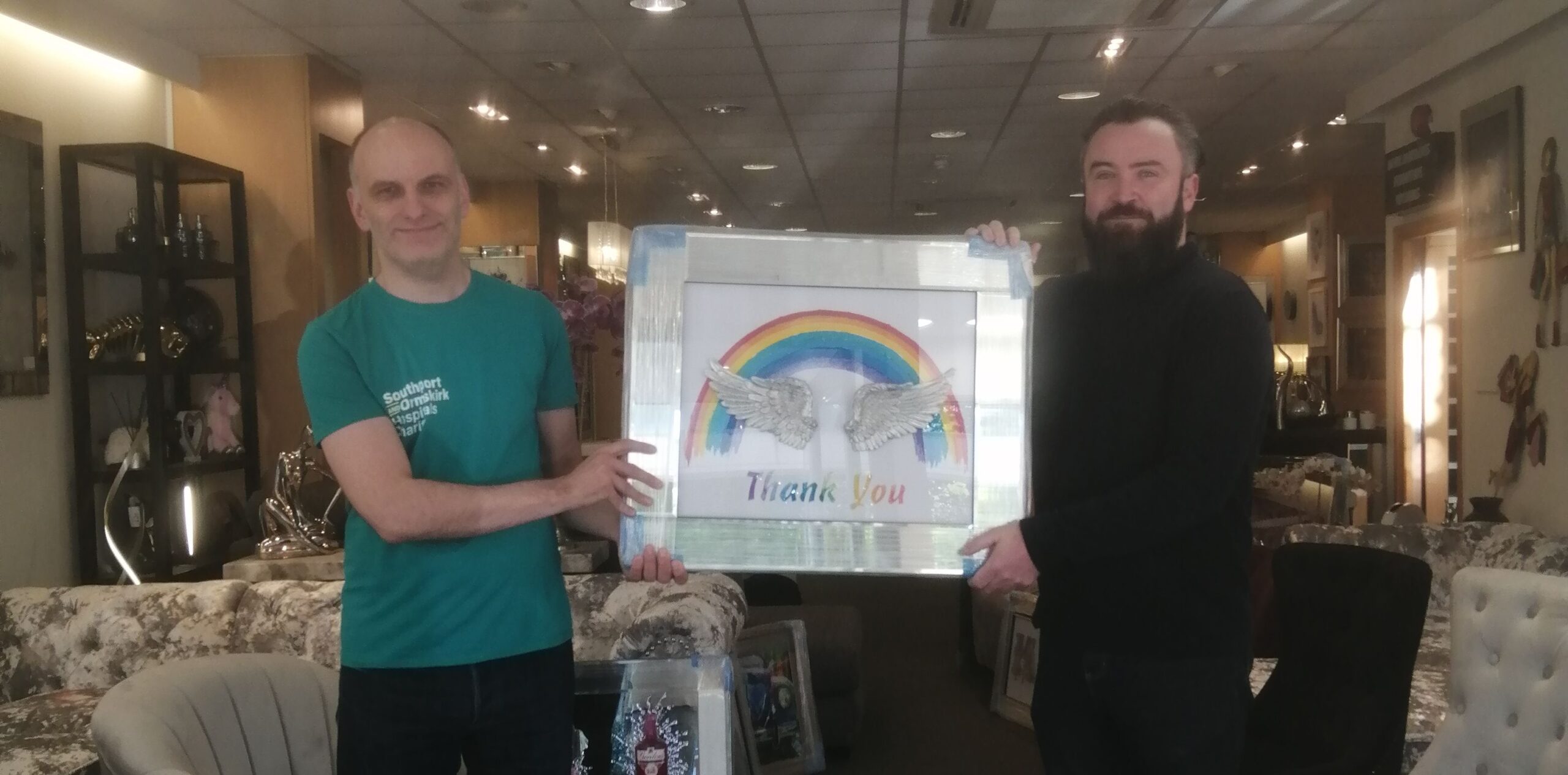 Andrew Byrne, the owner of Fabulous Furniture on Lord Street in Southport, donates a special picture to Ashley Flint from Southport & Ormskirk Hospital NHS Trust