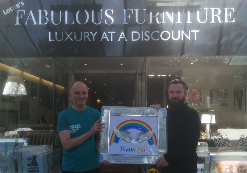 Andrew Byrne, the owner of Fabulous Furniture on Lord Street in Southport, donates a special picture to Ashley Flint from Southport & Ormskirk Hospital NHS Trust
