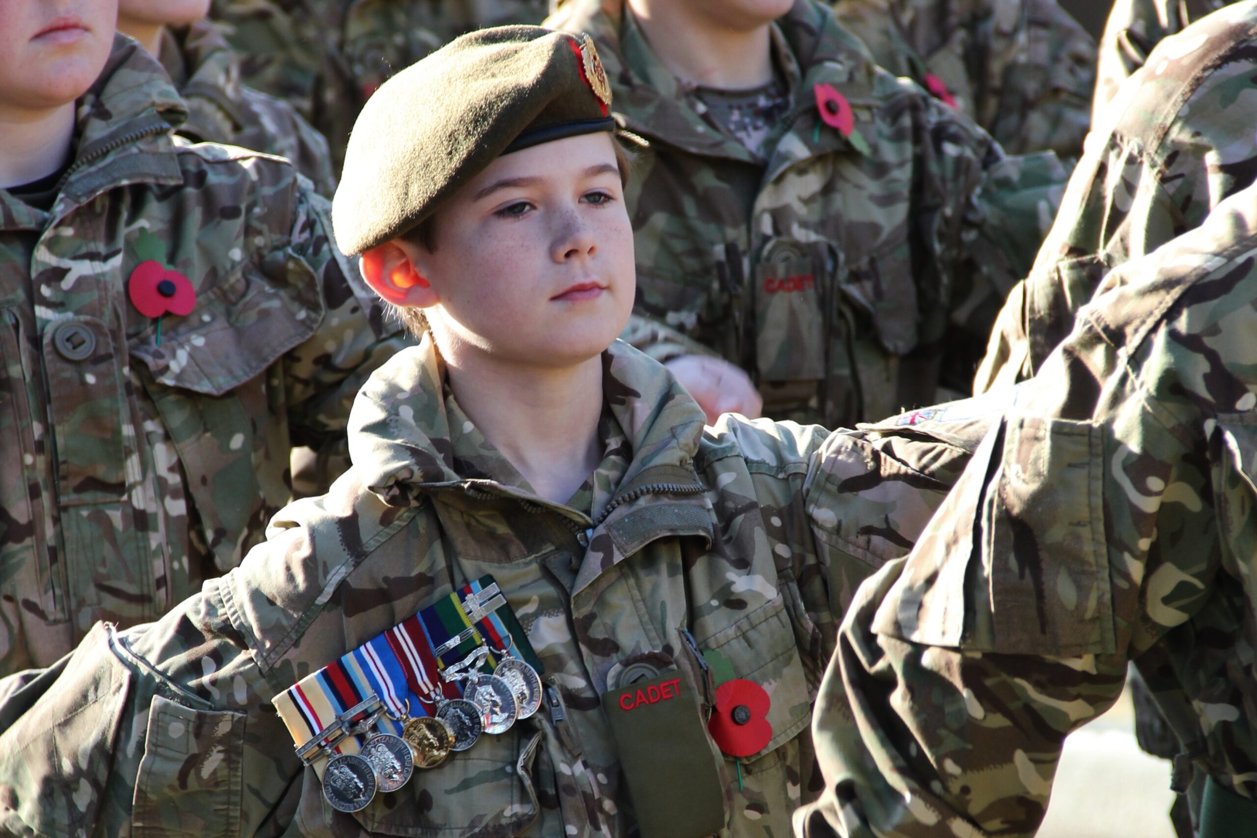 A young cadets wears his father's medals at a Remembrance Parade. Photo by Major Roy Bevan