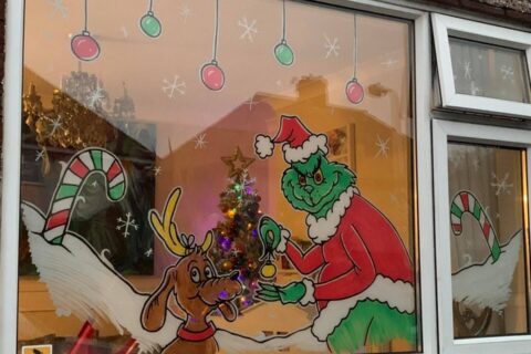 Christmas signwriter brings festive cheer to families with heart warming window designs