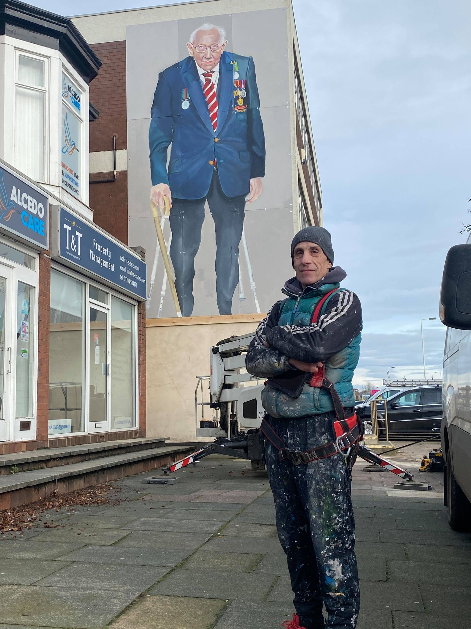 Artist Rob Newbiggin with the huge mural of Captain Sir Tom Moore in Southport