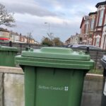 A green wheelie bin for garden waste recycling by Sefton Council