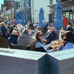 Customers enjoy a return to the Peaky Blinders bar on Lord Street in Southport after Covid lockdown restrictions were eased