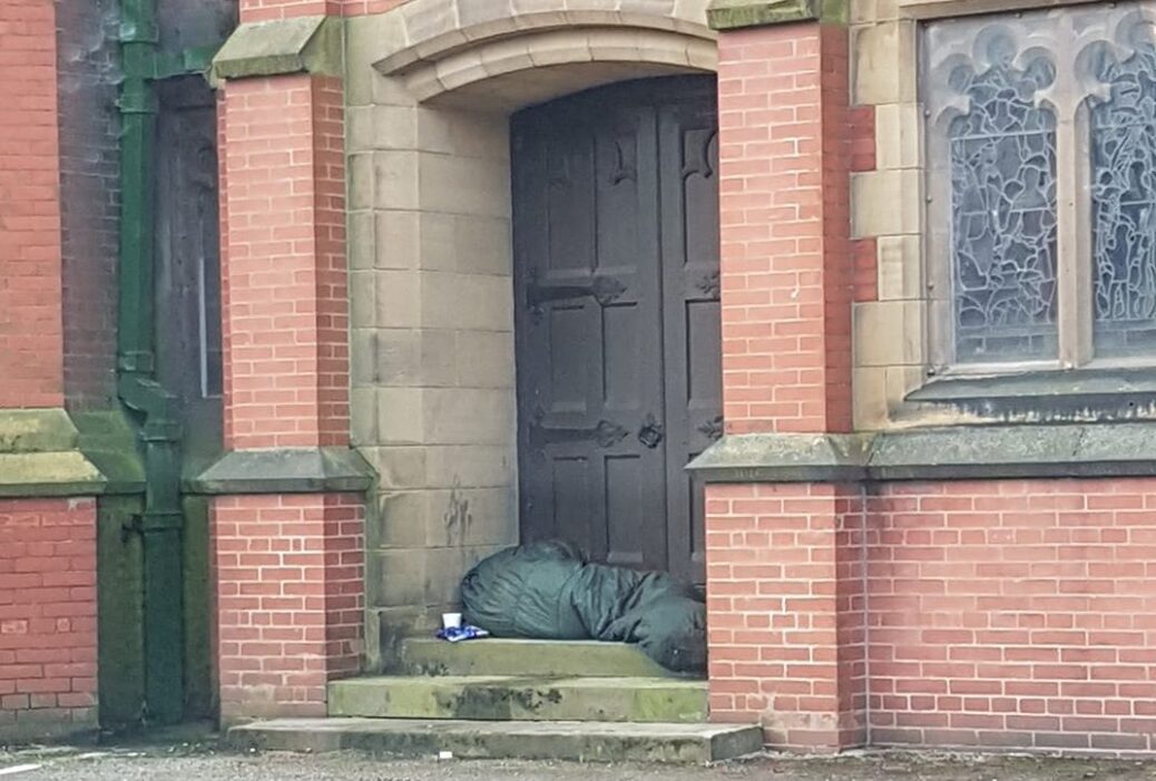 Homelessness in Southport as a person sleeps outside St Mark's Medical Centre