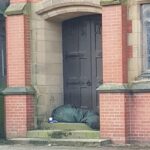 Homelessness in Southport as a person sleeps outside St Mark's Medical Centre