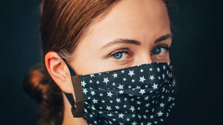 People are being asked to continue wearing face masks in crowded spaces
