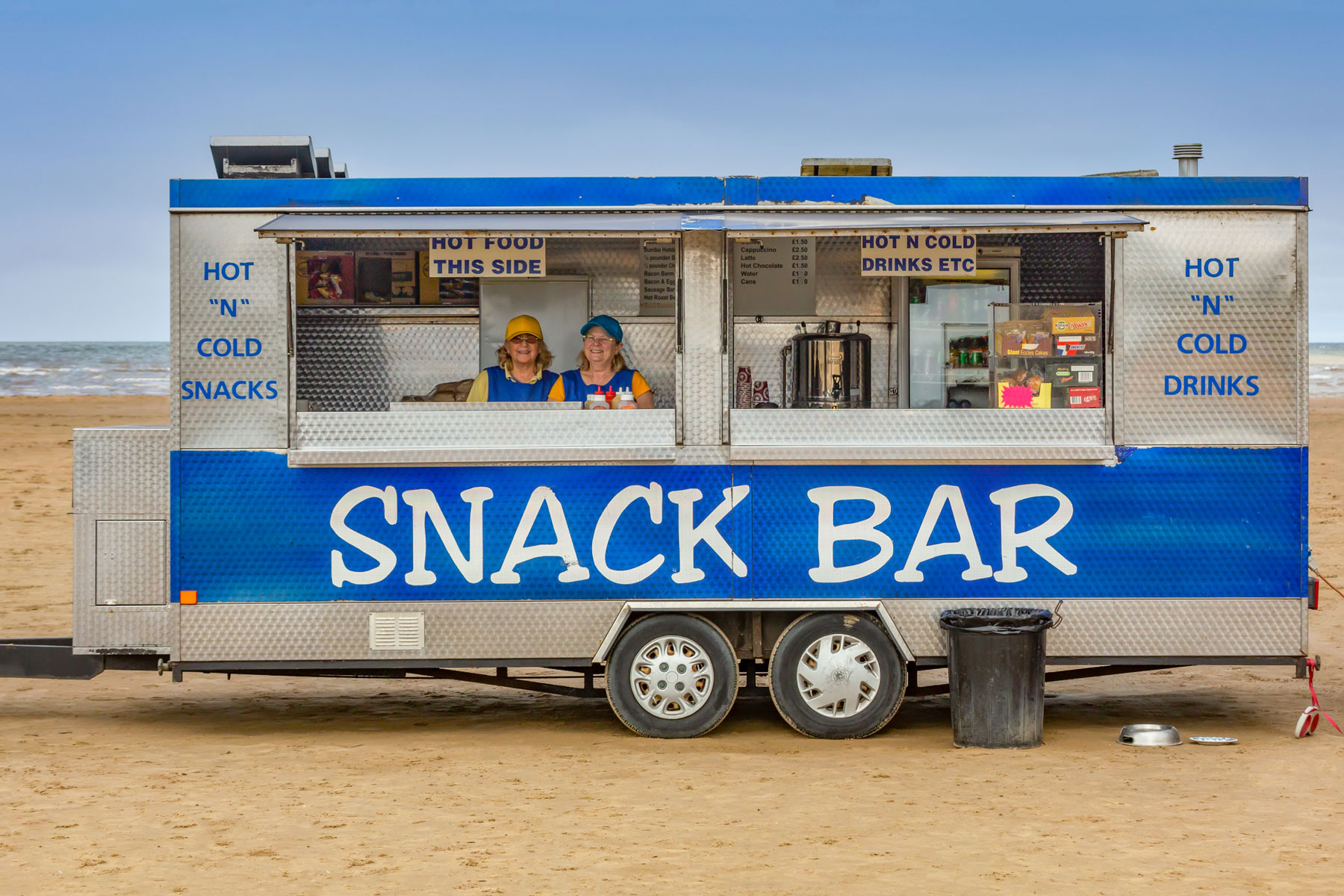 Kathy Lowe (in the yellow hat) is saying farewell to her customers after running the Snack Shack on Ainsdale Beach in Southport since 1978. Photo by Roger Green of Roger Green Photography