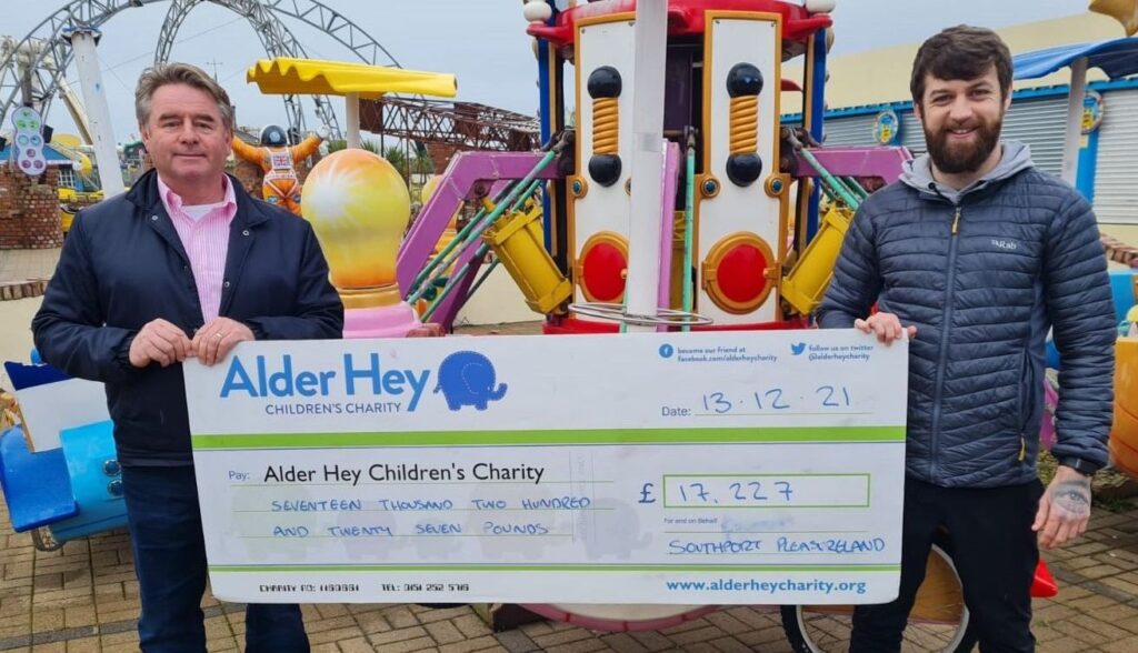 Southport Pleasureland CEO Norman Wallis presents a cheque for £17,227 to Alder Hey Childrens Charity community fundraiser Adam Dixon