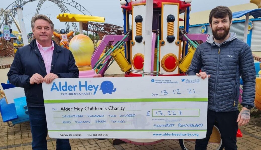Southport Pleasureland CEO Norman Wallis presents a cheque for £17,227 to Alder Hey Childrens Charity community fundraiser Adam Dixon