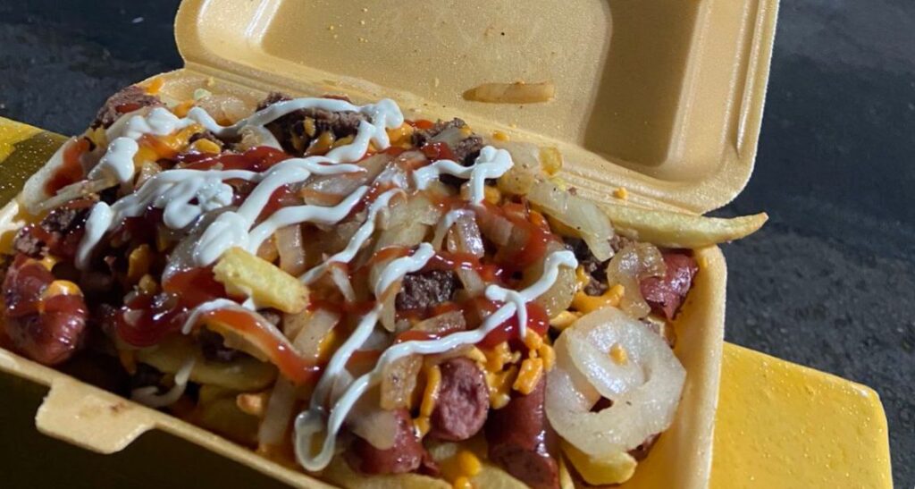 Dirty fries - fries, bashed burger, sausage, onions and cheese by Lourdes Deli at Southport FC. photo by FootyScran