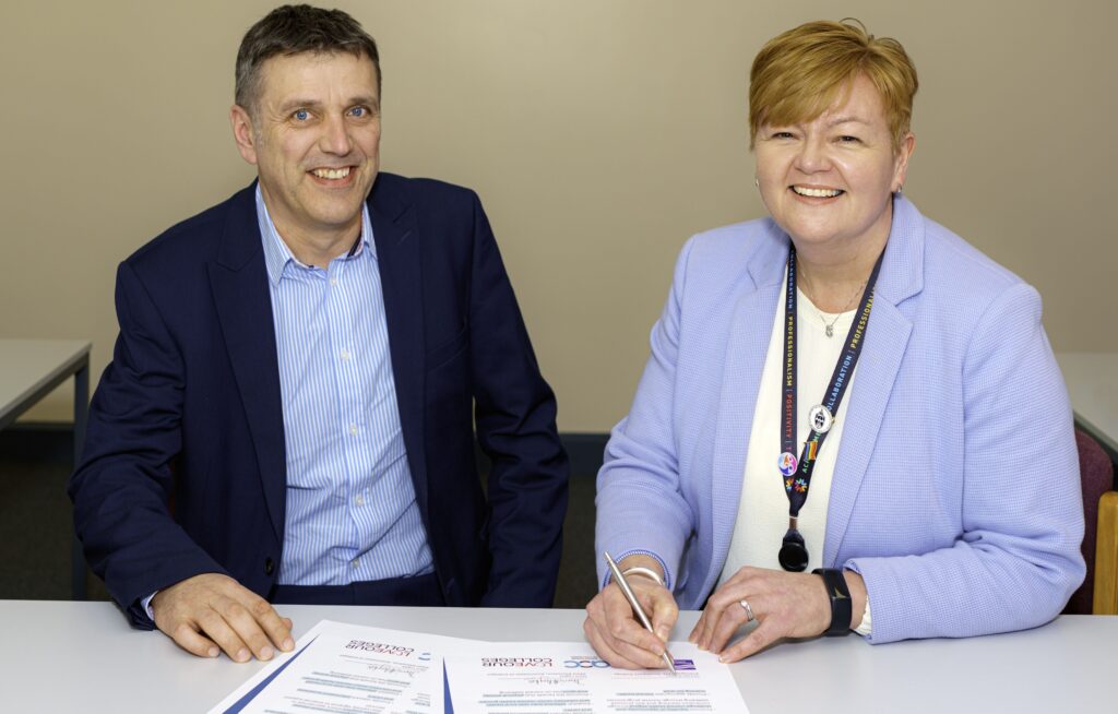 Principal Michelle Brabner signing the charter, alongside AOC Mental Health Lead Richard Caulfield