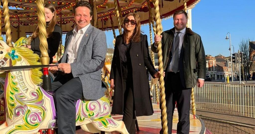 Tourism Minister Nigel Huddleston MP and Southport MP Damien Moore met Silcocks Leisure Group Operations Manager Serena Silcock and daughter Scarlett at the Carousel outside Funland in Southport. Photo by Andrew Brown Media
