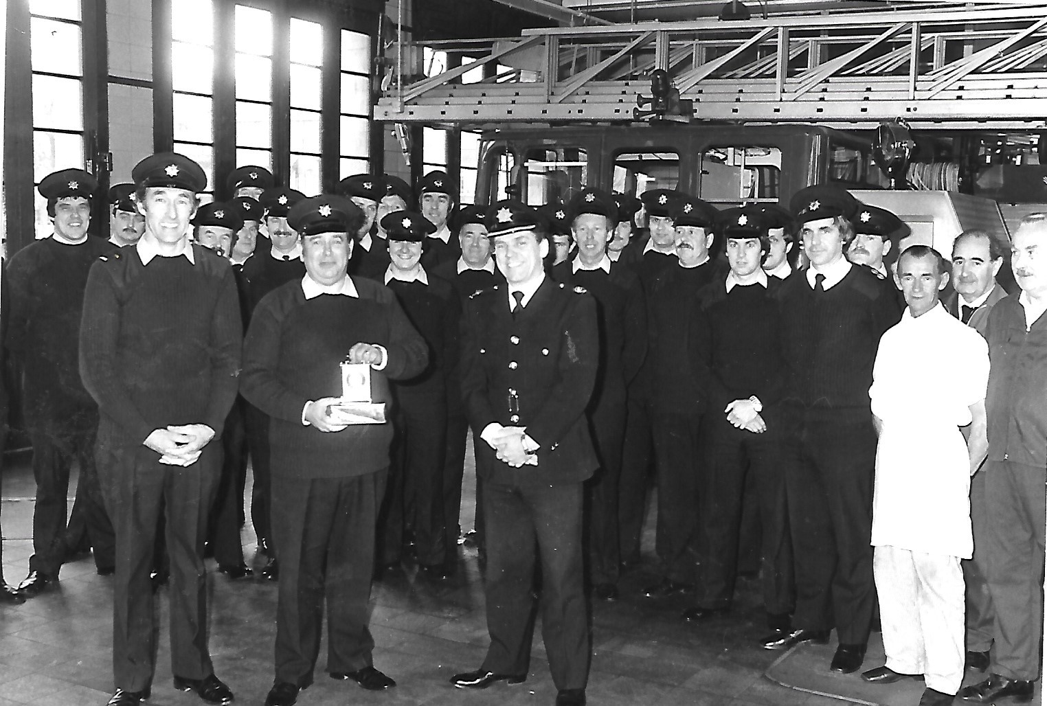Firefighters at Southport Fire Station gather to celebrate a retirement from the force in November 1982