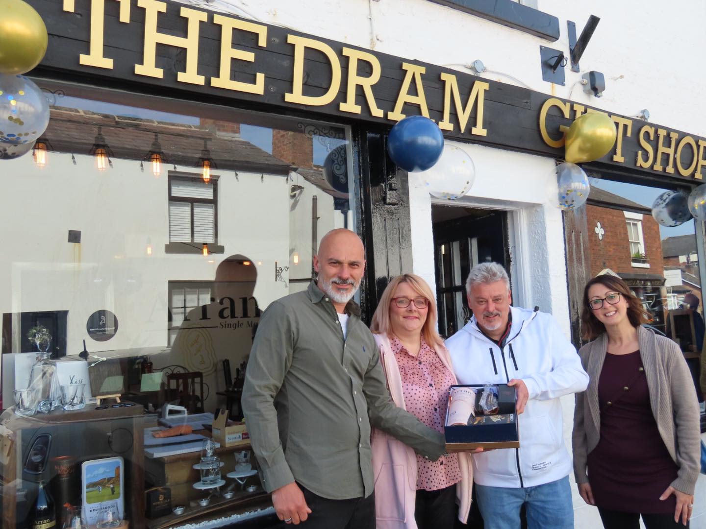 Darren and Rebecca Boyd-Preece with Linda and Paul Kewin, who won first prize in a Sandgrounder Radio competition, at The Dram Gift Shop in Churchtown in Southport. They won a special ten year old bottle of Arran Whisky and a selection of gifts worth £175 - a great way for Paul to celebrate his birthday. Photo by Andrew Brown Media