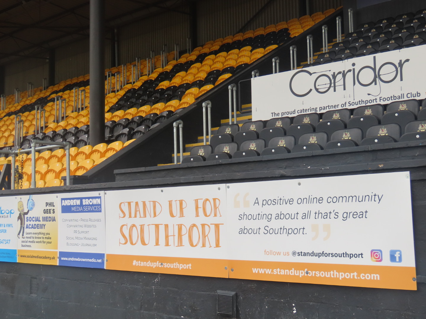 The Stand Up For Southport advertising board at Southport FC. Photo by Andrew Brown Media