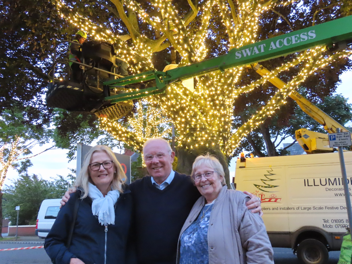 Ainsdale Village in Southport has been lit up with 70,000 new lights thanks to Ainsdale Civic Society and IllumiDex UK Ltd. Trish Ashcroft, Tony Brough and Joan Major from Ainsdale Civic Society celebrate the completion of the project. Photo by Andrew Brown Media