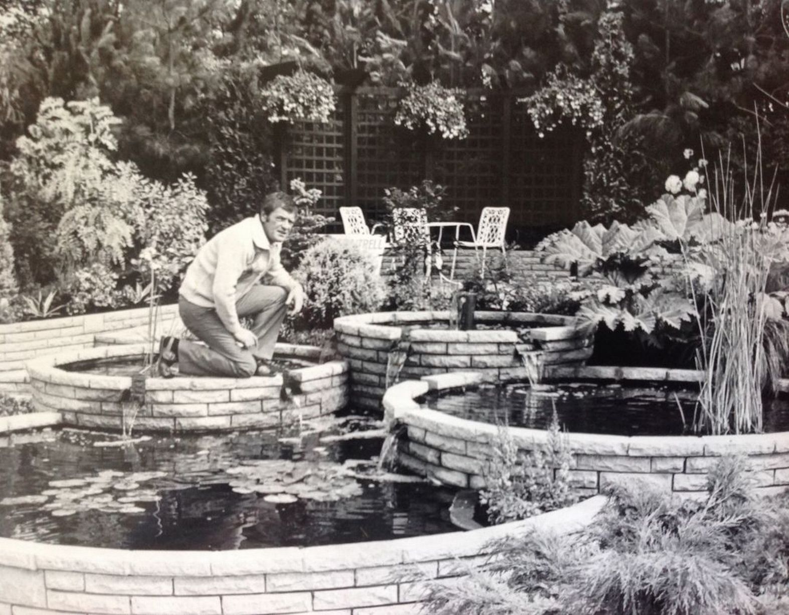 A gardener hard at work on his stunning show garden at Southport Flower Show in August 1984