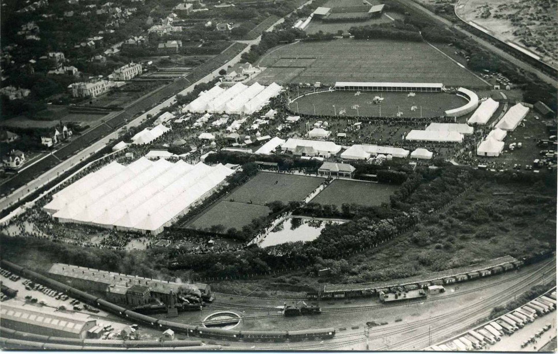 Undated aerial photo of Southport Flower Show in Victoria Park in Southport, showing the equestrian show ground, the floral marquees, and the railway line running past. Photo by George Latham