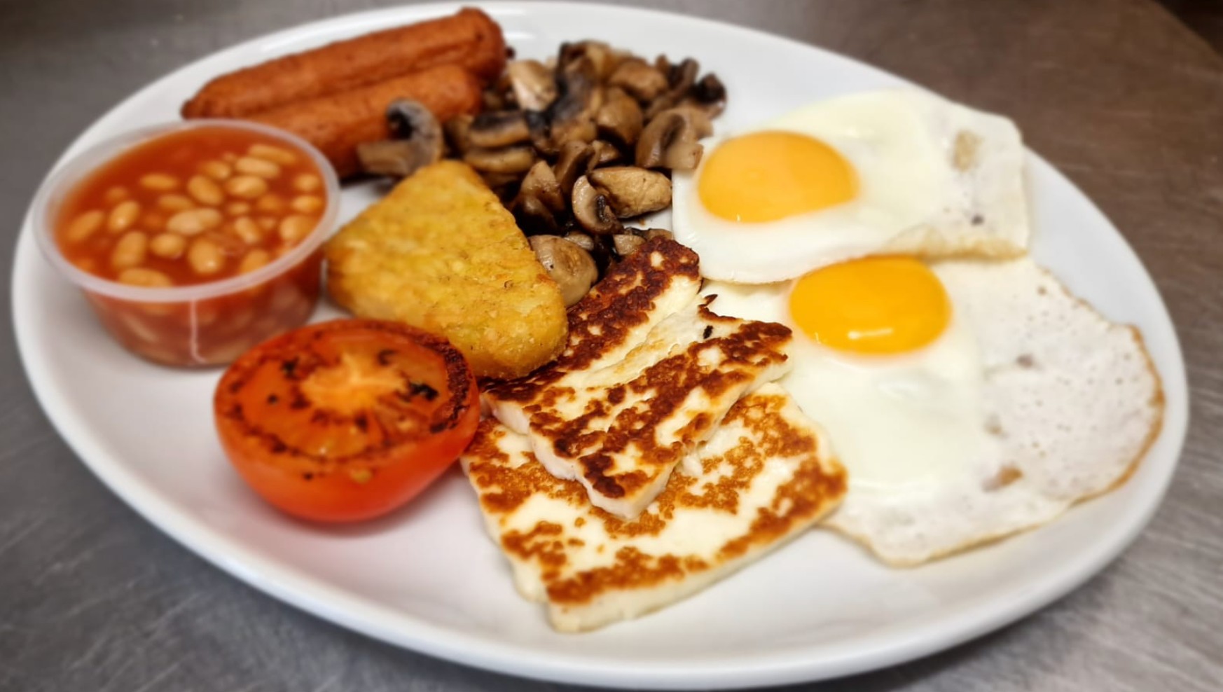 The Veggie Breakfast of dreams at RA Bar in Southport with Linda McCartney sausages, grilled halloumi, sautéed mushrooms, roasted tomato, egg, beans, and sourdough bread toasted
