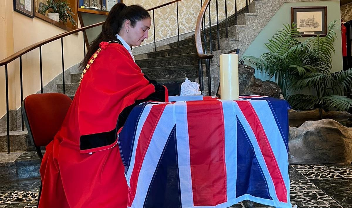 Mayor of Sefton Cllr Clare Carragher signs the Book of Condolence for Queen Elizabeth II at Bootle Town Hall