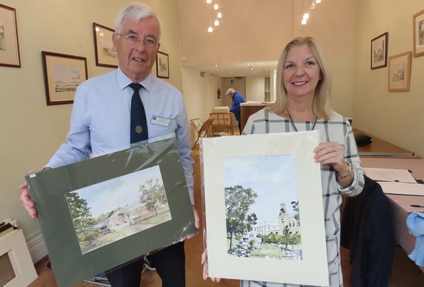 A special exhibition, John Duffy Watercolours, is taking place at Wayfarers Arcade on Lord Street in Southport town centre in collaboration with Johns family and The Rotary Club of Southport. Keith Mitchell from Southport Rotaary with Yvonne Burns from Wayfarers Arcade. Photo by Andrew Brown Media