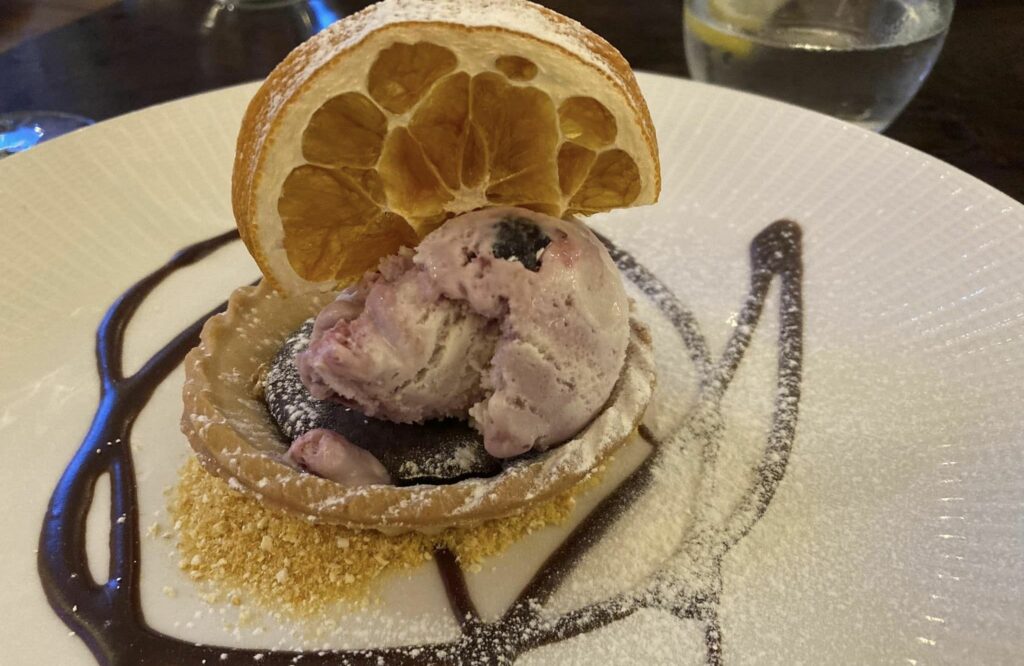 Christmas at The Grand in Southport. Chocolate orange tart with chocolate sauce, candied orange and ice cream