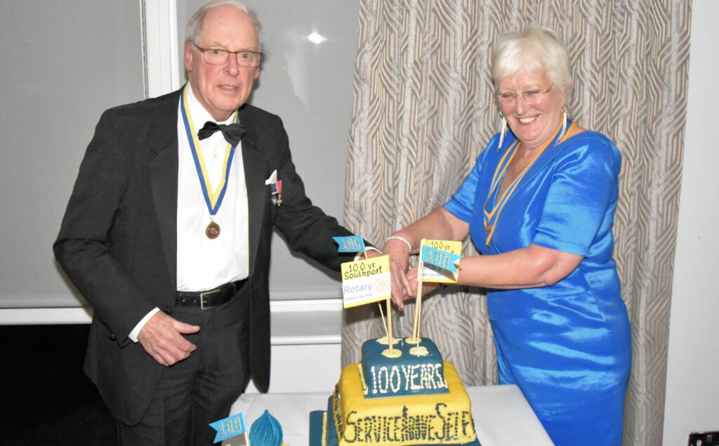 Guests enjoy the Rotary Club of Southport Centenary Charter Dinner. The cutting of the cake by President Glenys Critchley and David Roberts. Photo by Ian Hitchcock