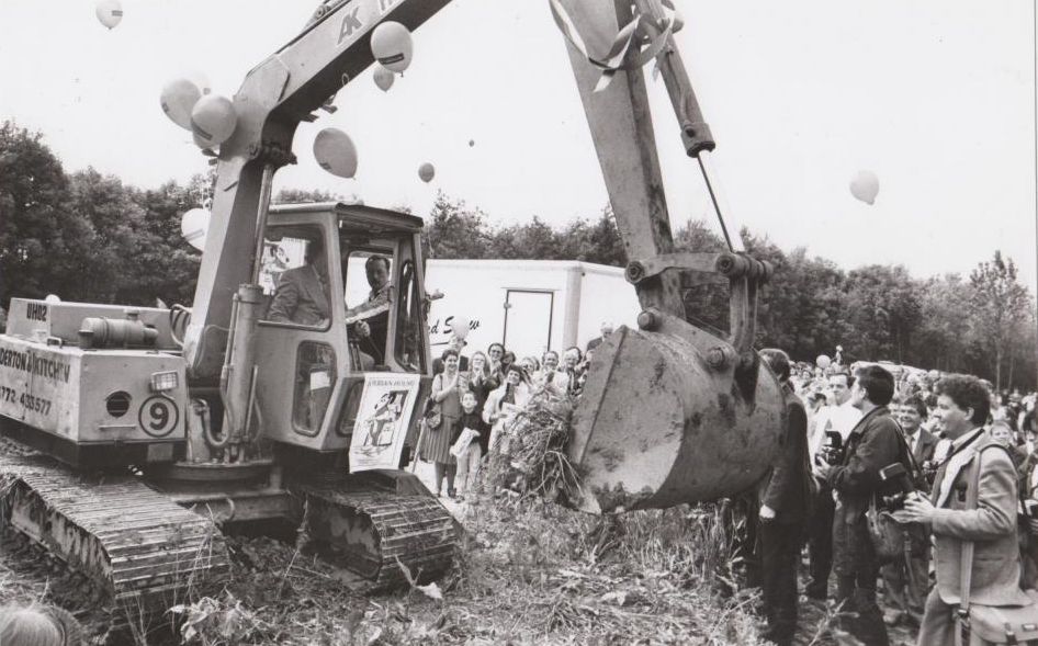 Ken Dodd gets behind a JCB to dig the Deriian House hospice foundations at the 1992 ceremony