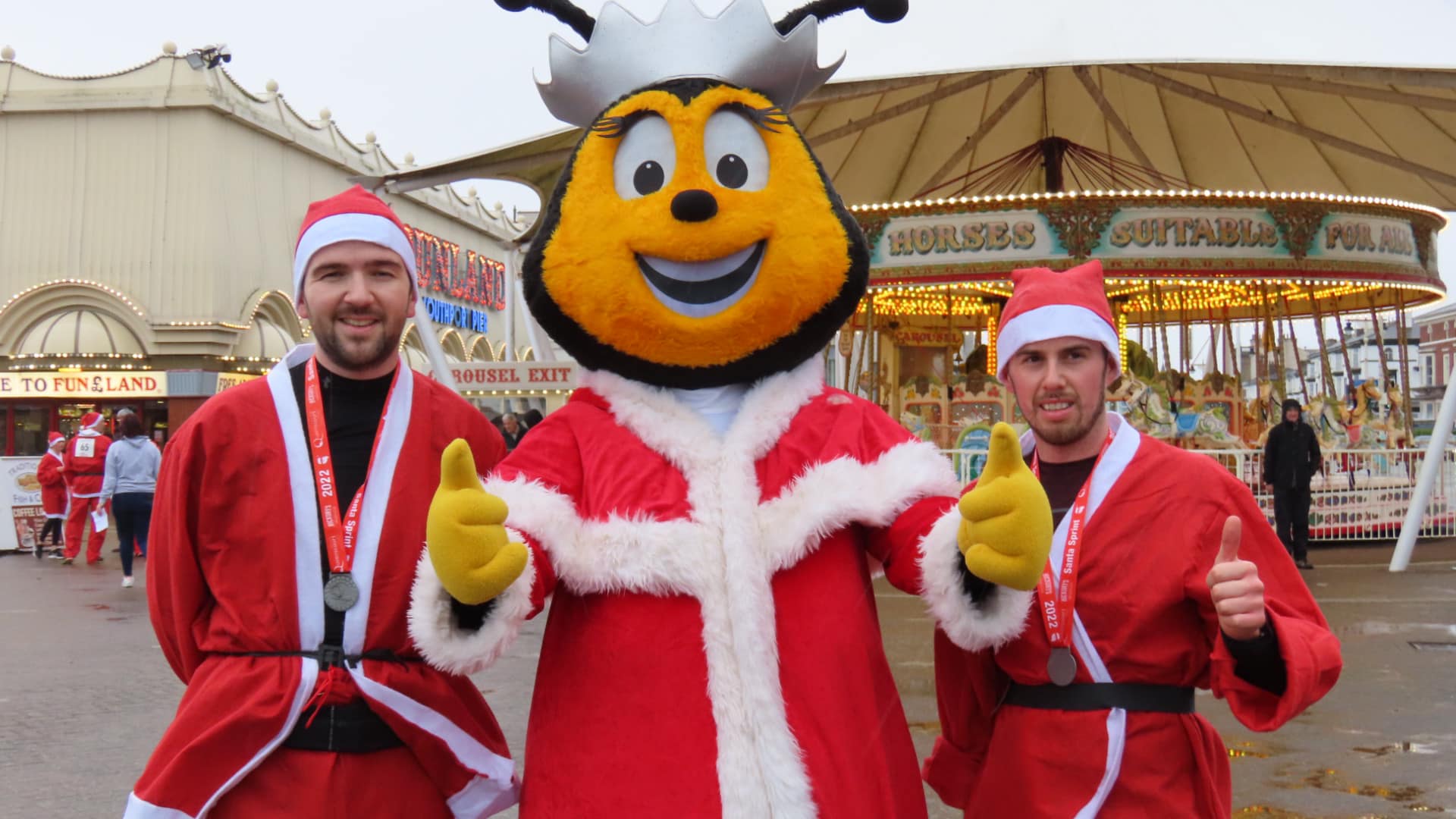 Runners enjoyed the Southport Santa Sprint for Queenscourt Hospice sponsored by Silcock's. Queenie the Bee with Oliver Halstead who won the race (left) and Ryan Pike (right) who was a close second. Photo by Andrew Brown Media