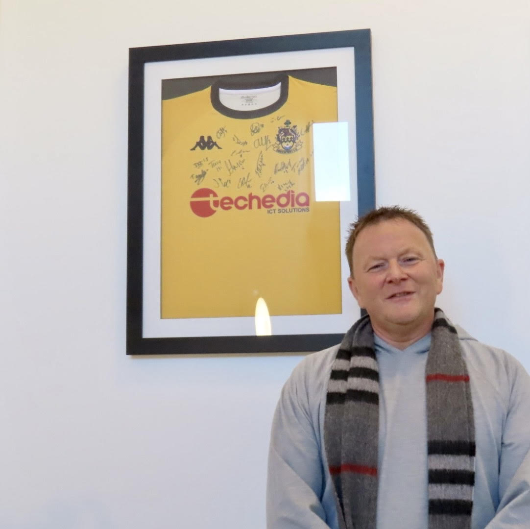 Techedia Managing Director Matthew Townson with a Southport FC shirt inside the Techedia offices at the Cloisters Building on Corporation Street in Southport town centre. Techedia is the main sponsor for Southport FC. Photo by Andrew Brown Media