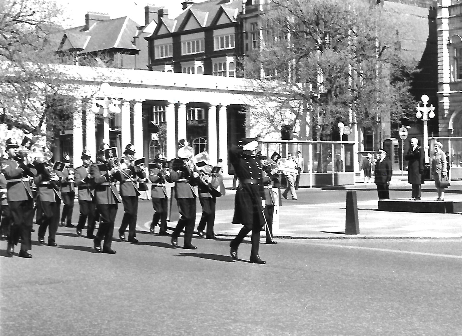 A marching band makes its way along Lord Street in May 1982 as the Mayor of Sefton takes the salute on a platform next to The Monument