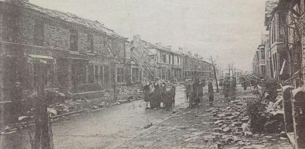 The morning after an October raid in 1941 in Worcester Road in Bootle during World War II. Householders and passers-by survey the damage