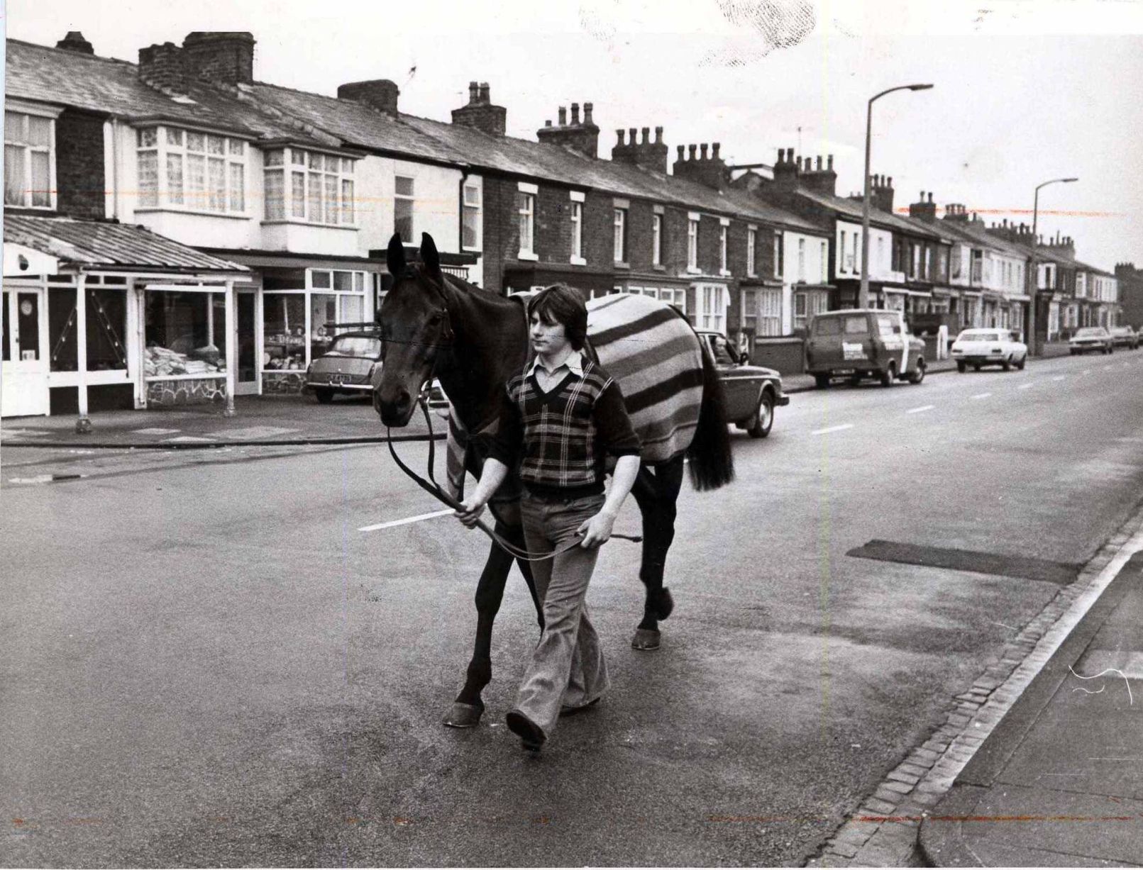 Stable lad Billy Beardswood takes Red Rum for a stroll through the streets of Southport in April 1978
