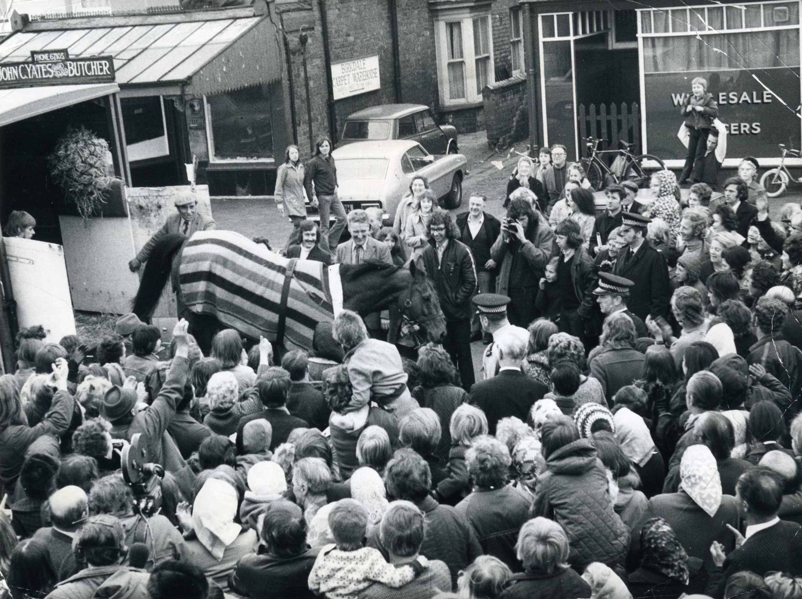 A triumphant Red Rum is welcomed by the crowds back to his stables in Birkdale, Southport, after his dramatic Grand National victory in 1973