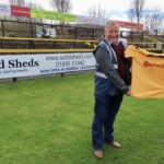 Solid Sheds owner Andy Hayes and Steven Brown from Southport FC next to the new Solid Sheds advertising board at Southport Football Club. Photo by Andrew Brown Media