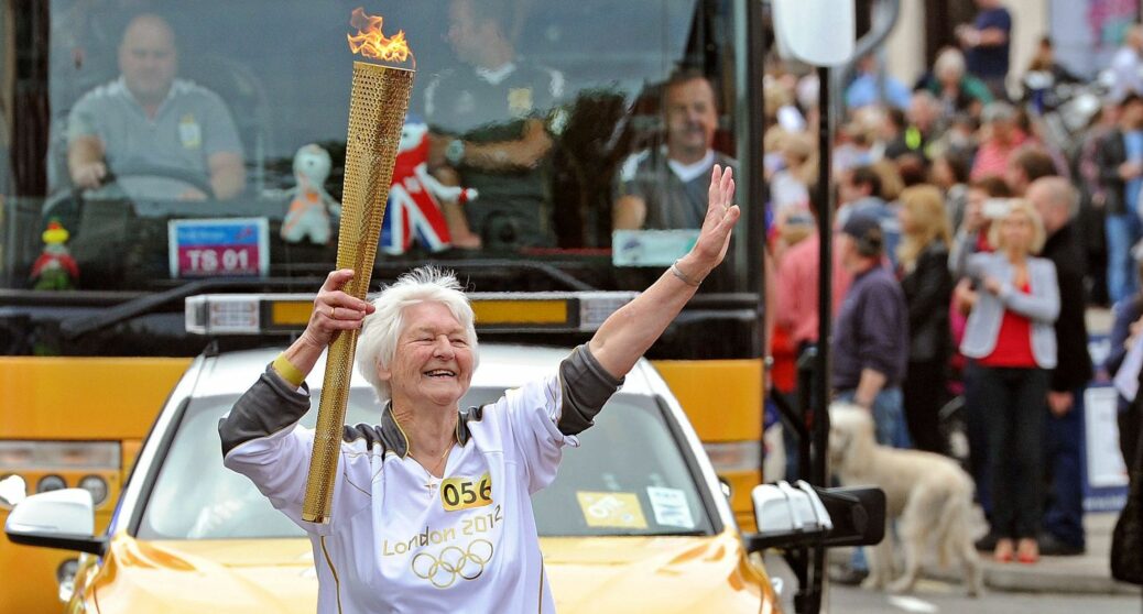 Hilda Blomley carries the Olympic Torch in Southport in 2012