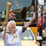 Hilda Blomley carries the Olympic Torch in Southport in 2012