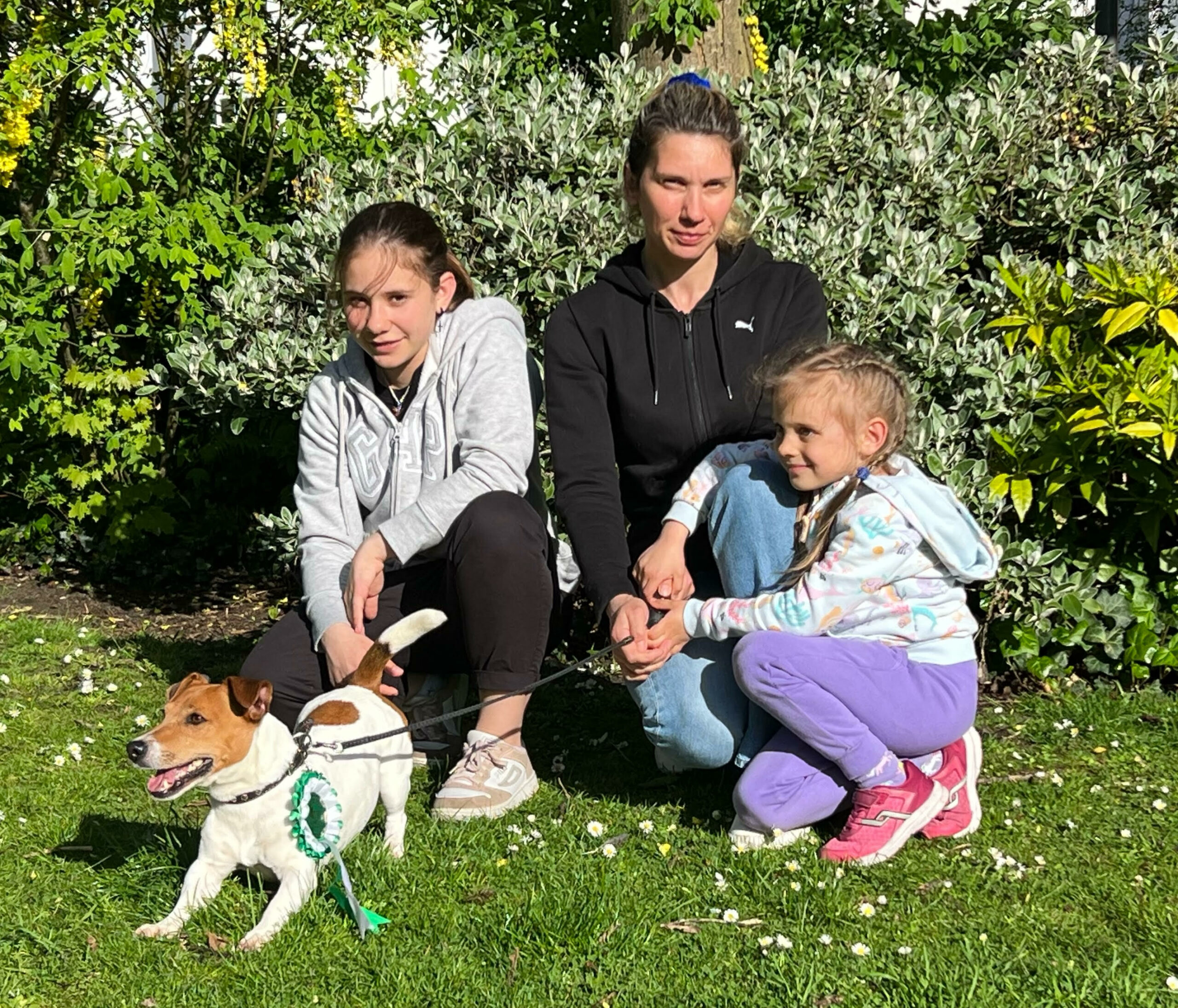 Spike, the wonder dog who has left Ukraine for a new home in Southport. Also pictured:  Mum - Dalyna Burlachenko; Elder daughter - Kristyna; Younger daughter - Kateryna