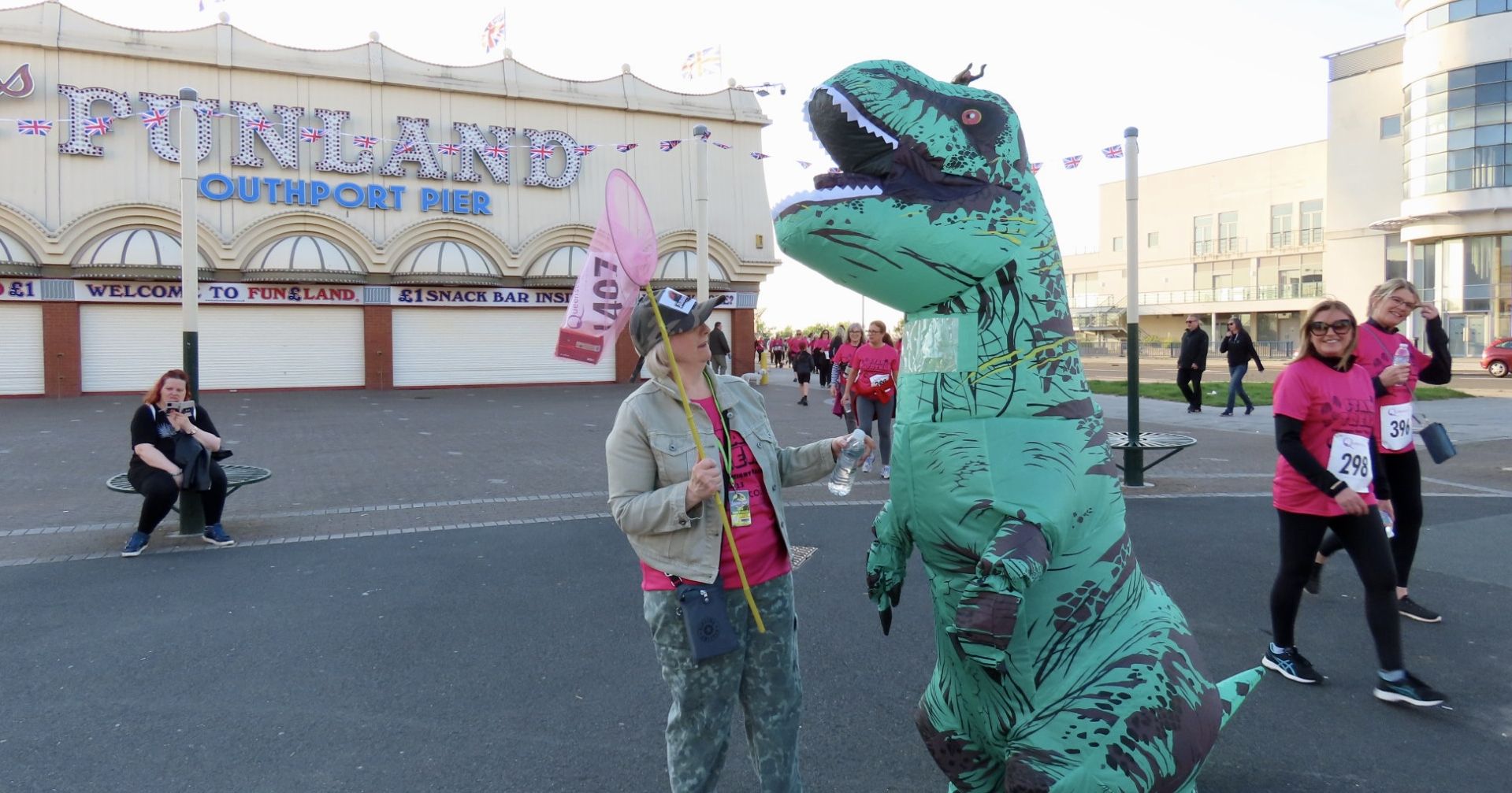 Joanne Caddy and Amanda Bradley were inspired by Jurassic Park to raise funds for Queenscourt Hospice by walking 10 kilometres through the streets of Southport - dressed as an 8ft tall Tyrannosaurus Rex dinosaur and a Jurassic Park Ranger! Photo by Andrew Brown of Stand Up For Southport