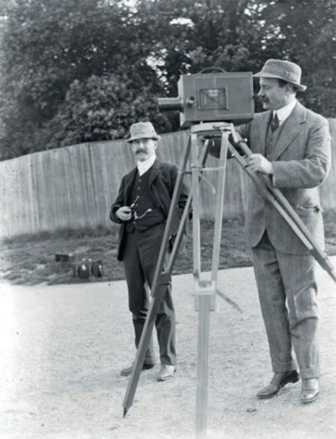 Camera designer Arthur Newman teaching Herbert Ponting to use a Newman-Sinclair kinematograph in preparation for Scotts expedition. (From glass negatives previously owned by Ponting and/or Newman, image © A. Strathie)