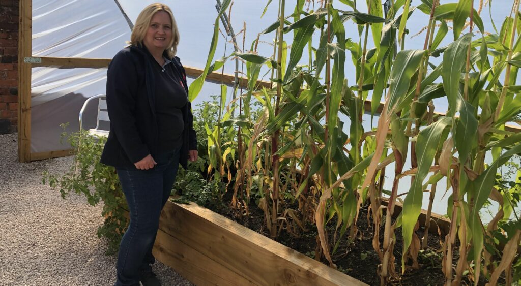 Kathryn Casserley, Community Programme and Engagement Manager at Southport Corps stands with the corn that has been grown in the community garden