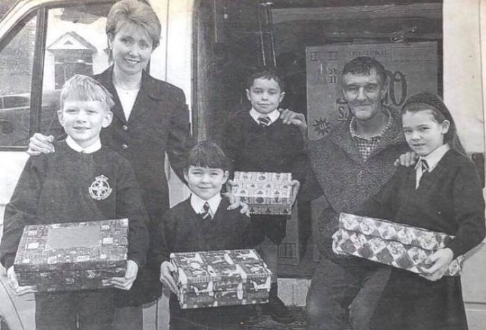 Our Lady of Lourdes caretaken Roger Walton, headteacher Susan Wilson and pupils with some of the shoeboxes the pupils sent to Liberia in December 2000. Also pictured are pupils Robert Scanlon, Delyth Owens, Daniel McNaughton and Beth Jolly. Phoot by Rob Lovett